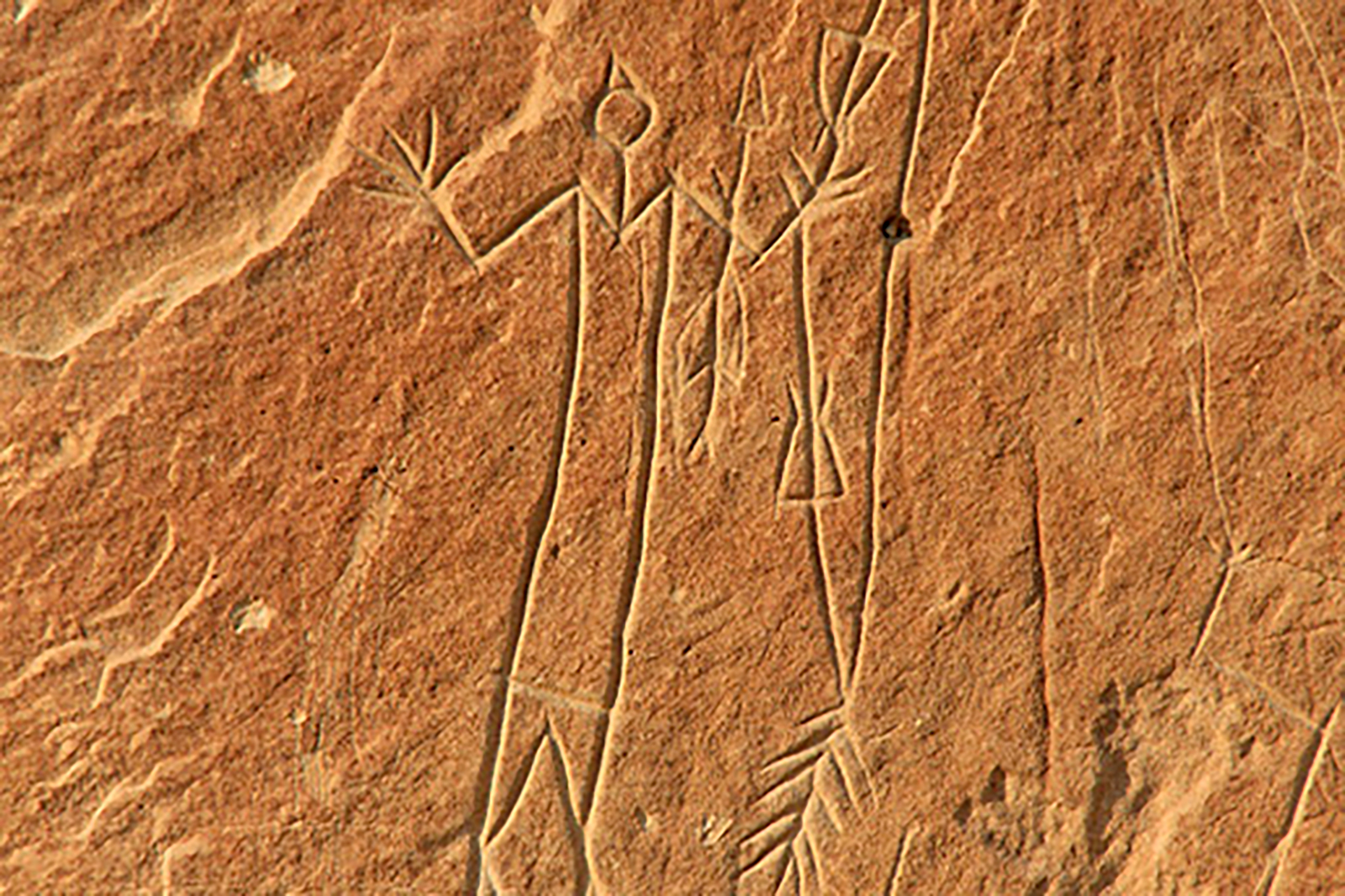 V-necked human with a quiver of arrows Writing-On-Stone Áísínai'pi Provincial Park, Alberta, Canada