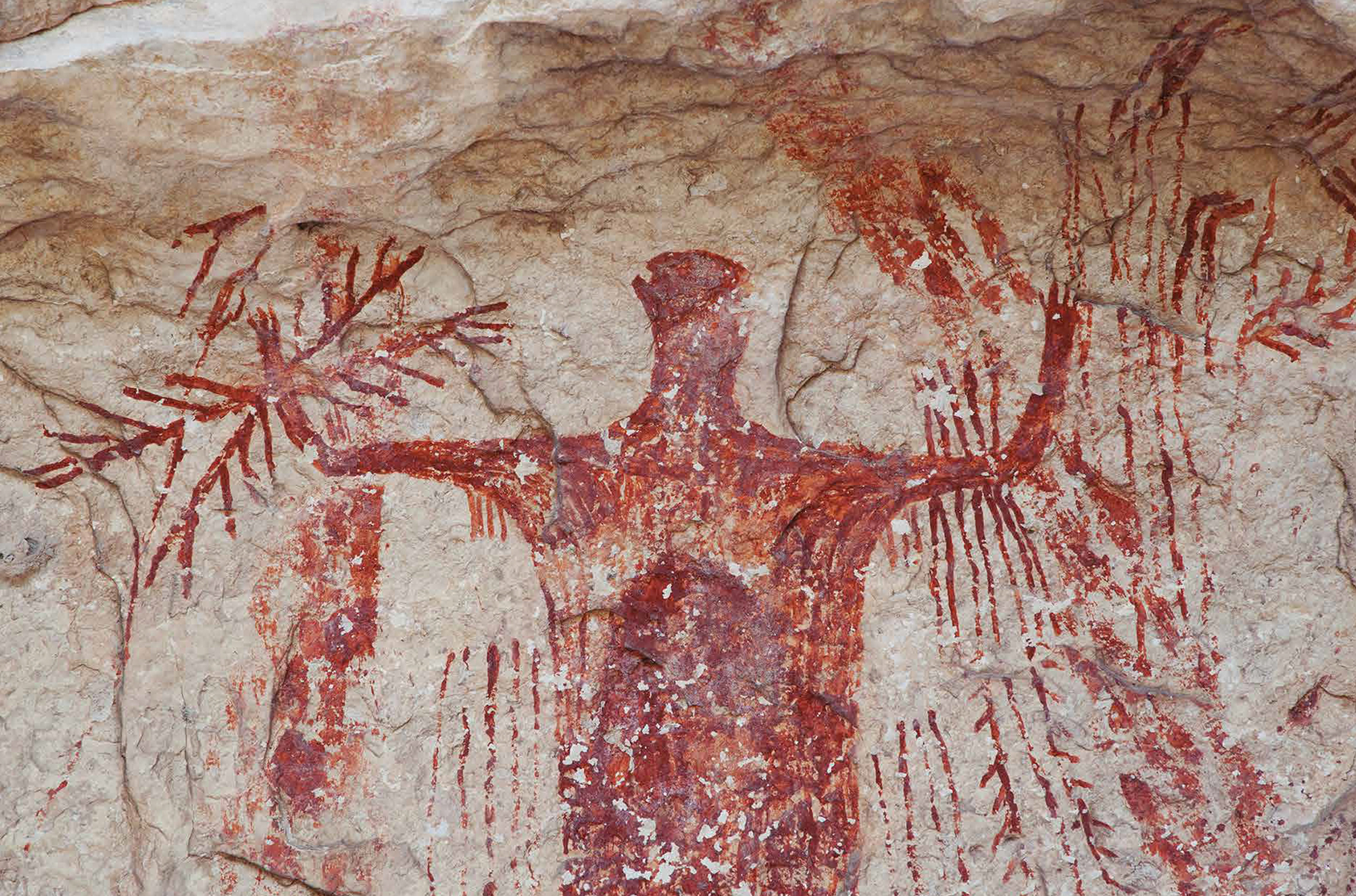 This powerful, red anthropomorph from Panther Cave displays a wide range of body adornments, paraphernalia, and weaponry