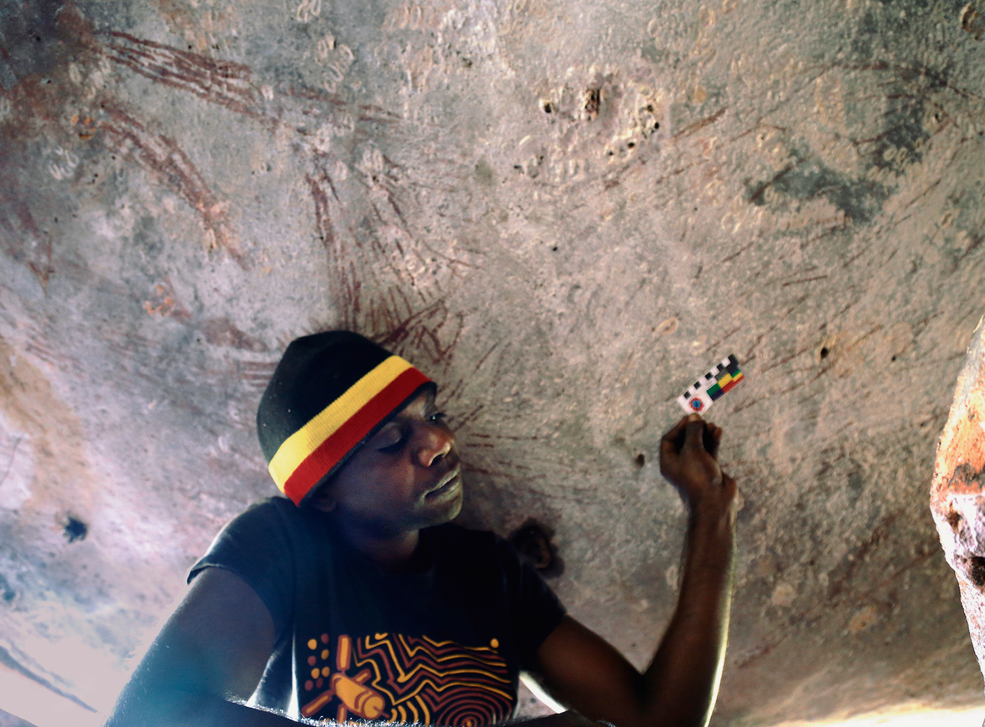 Traditional Owner Ian Waina with the kangaroo painting that was dated between 17,500 and 17,100 years old
