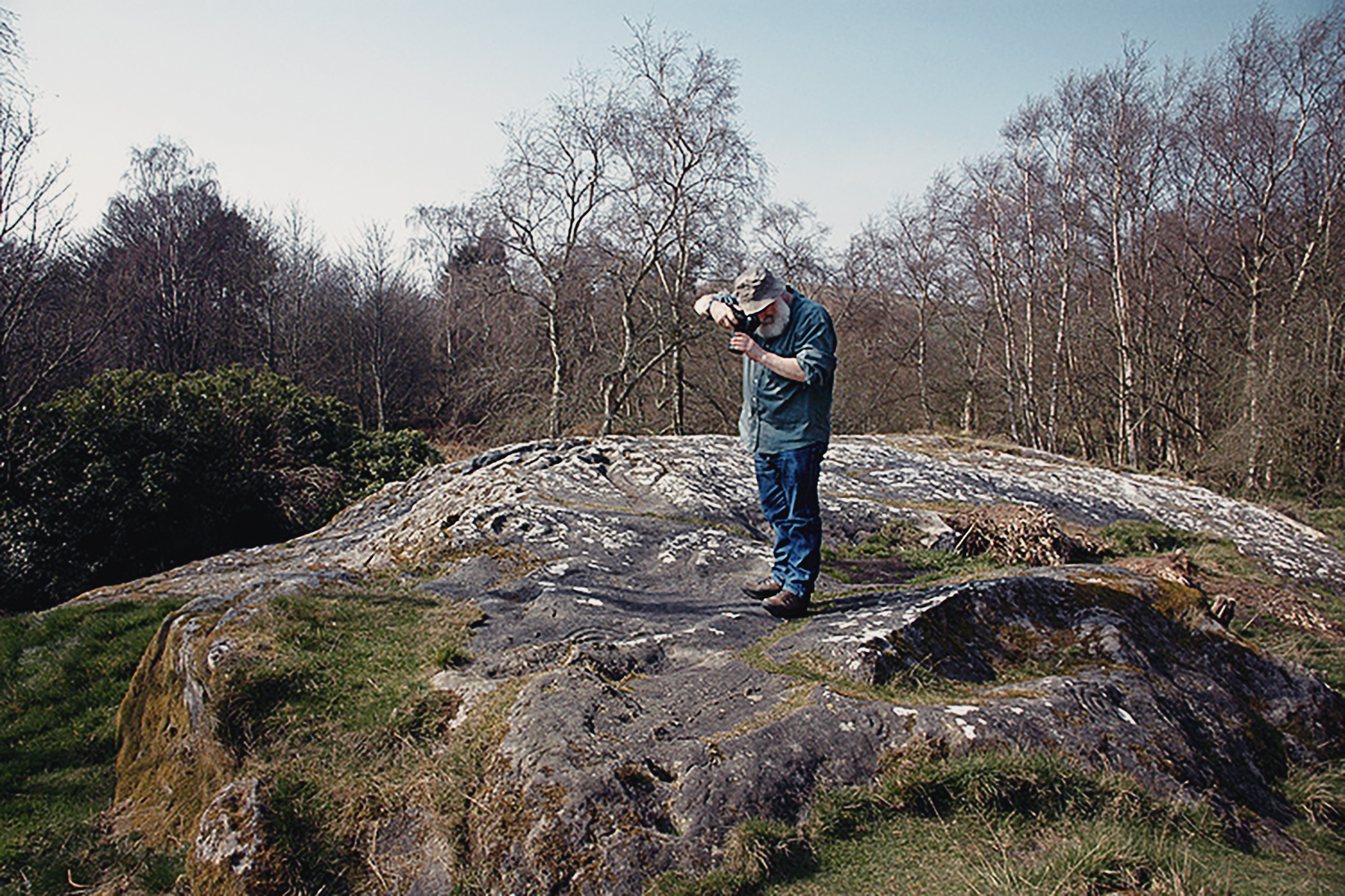 Dr Aron Mazel recording the rock art carvings of Northumberland, England