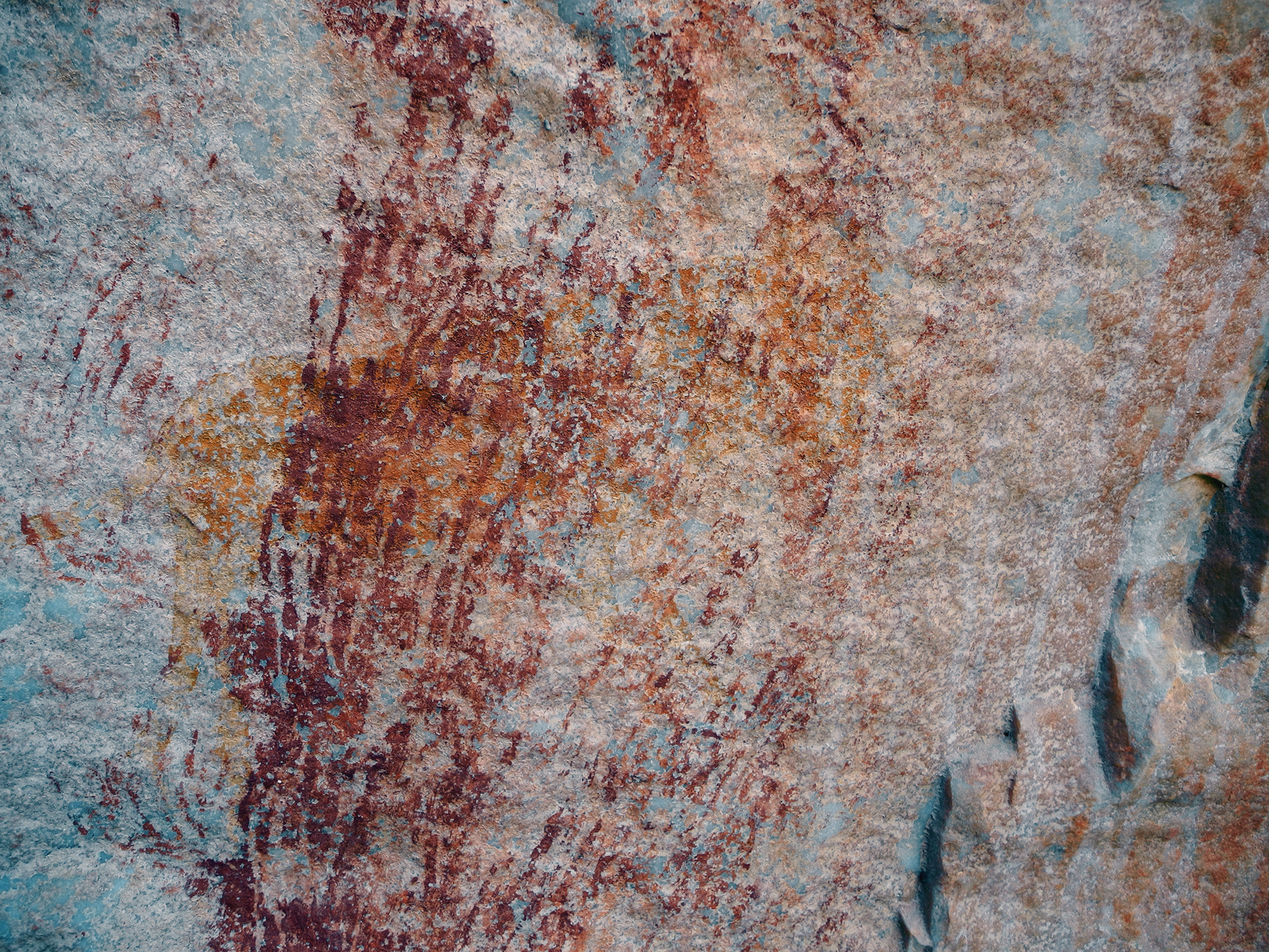 Rock Art Handprints with extended fingers superimposed over a yellow feline, Swartkop, Ceres Karoo Archaeology South Africa