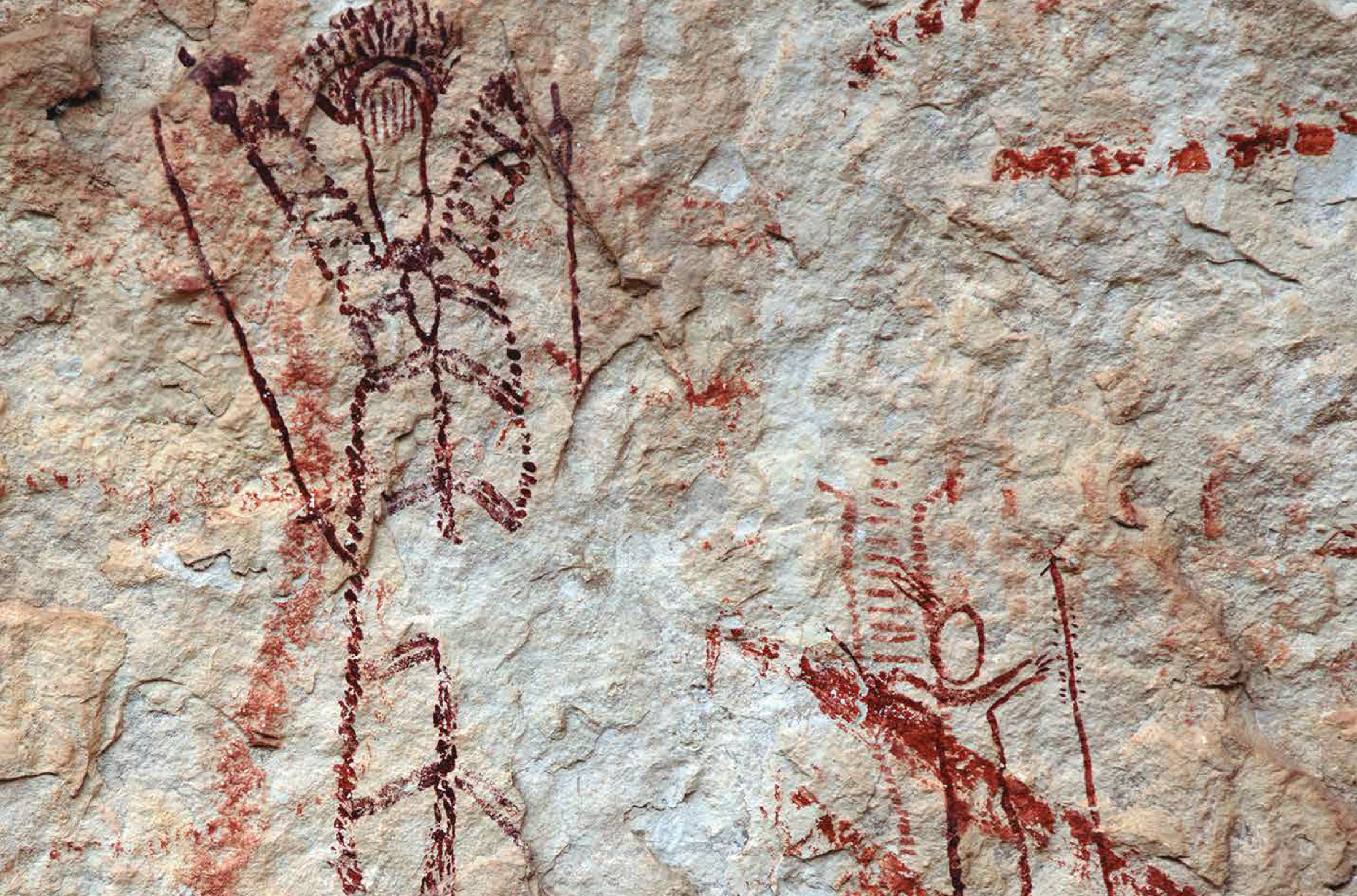 Artists used natural features in the rock to serve as the eyes and nose of the taller figure on the left