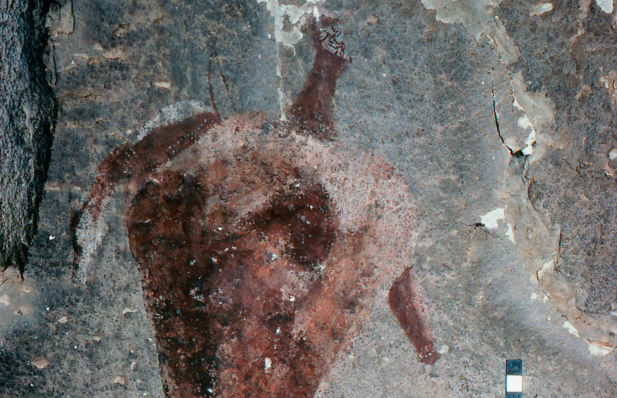 A shaded robust human figure from Pager’s Shelter appearing to hold with a rhebuck over its shoulder. The scale is 10cm long.